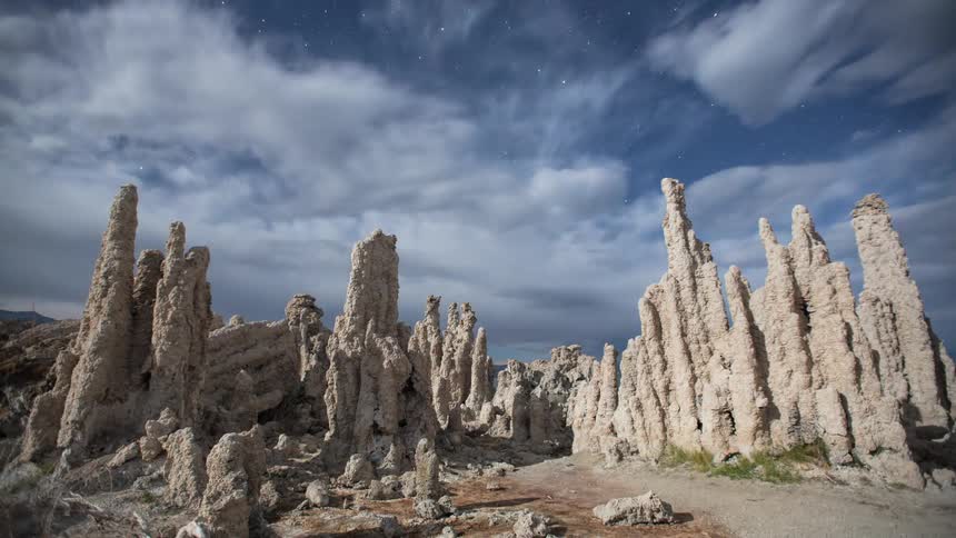 Clouds roll overhead of tall rock formations