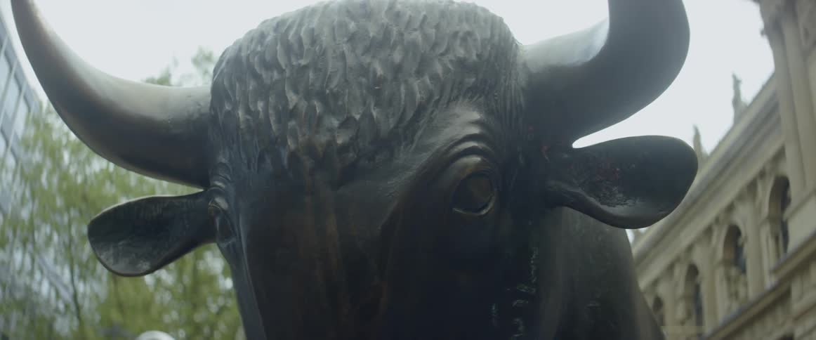 A bull statue stands in a city