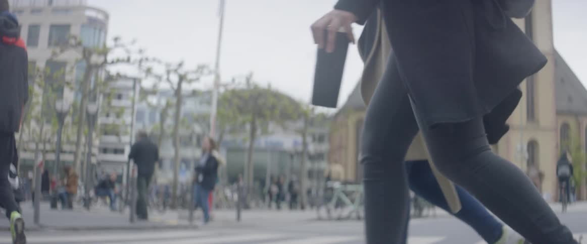 People walking across a crosswalk in a city