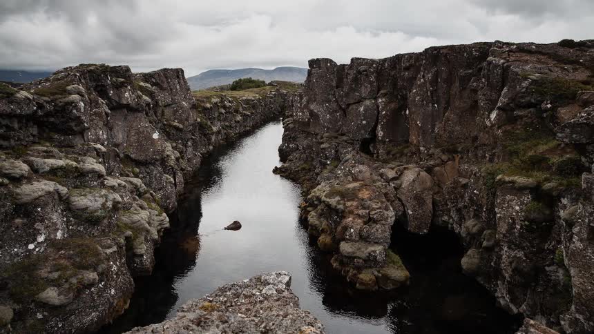 Water runs between rock formations on an overcast day