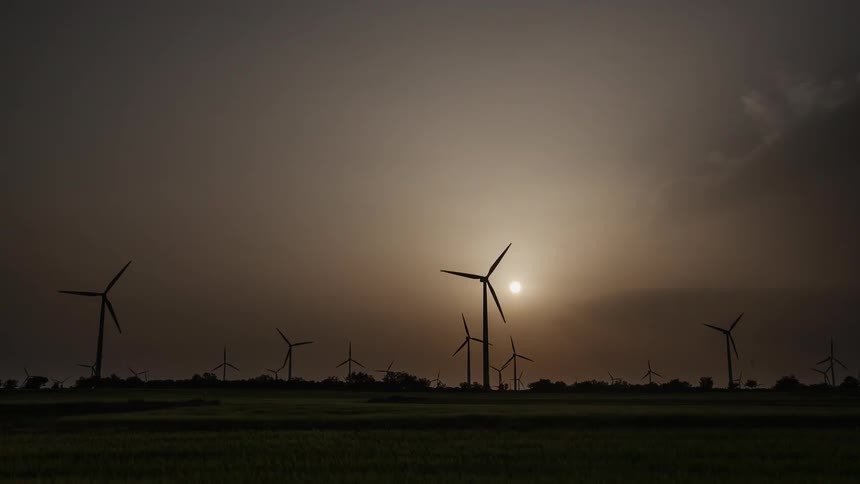Wind turbines operate as a the day progresses from afternoon to dusk