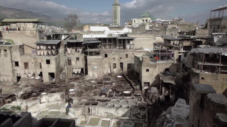 Tattered buildings and small concrete pools cover the grounds