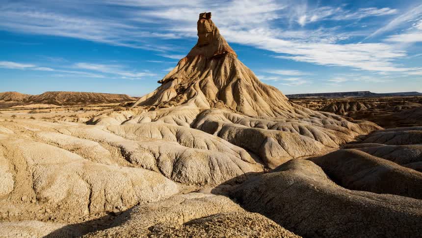 Clouds float over a desert rock formation