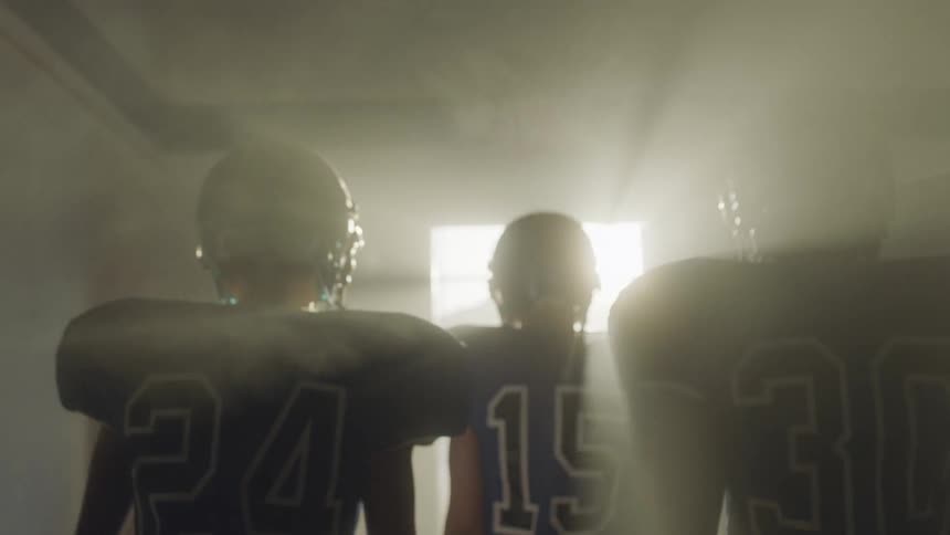 Football players in a tunnel