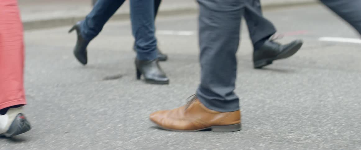 People cross a city street