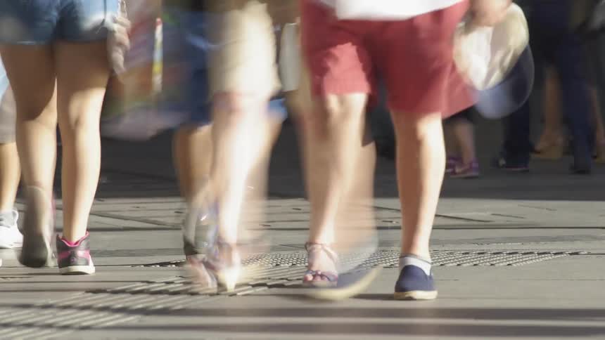 Pedestrians walk on a sidewalk