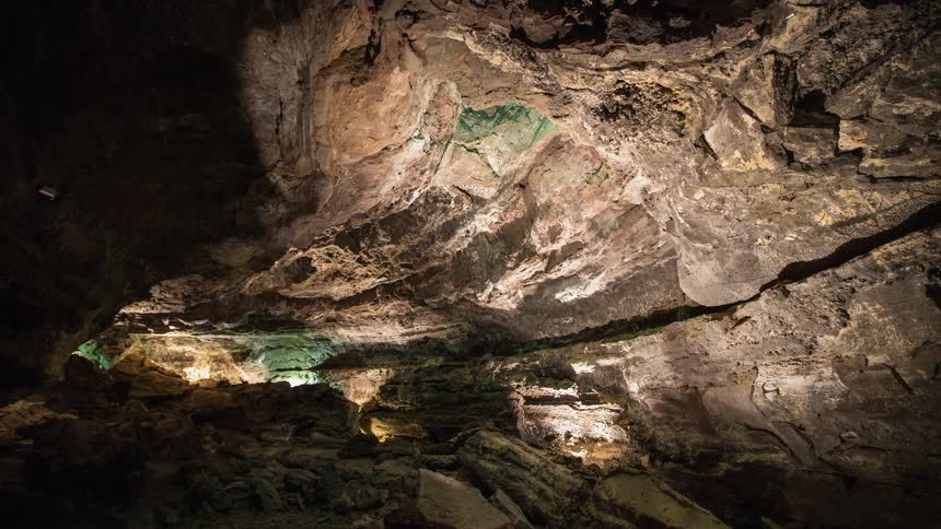 Sunlight shines on the rock walls of a cave