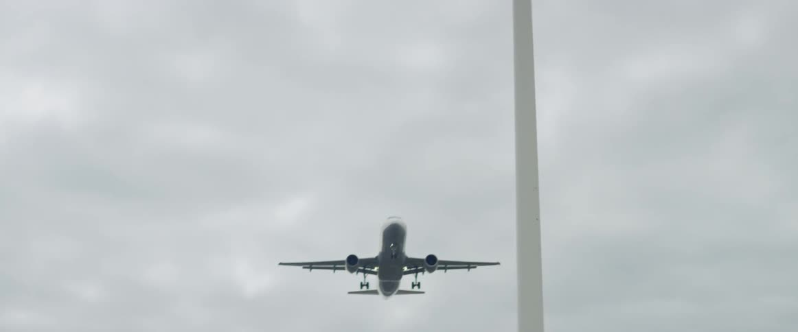 A jet flies in a cloudy sky