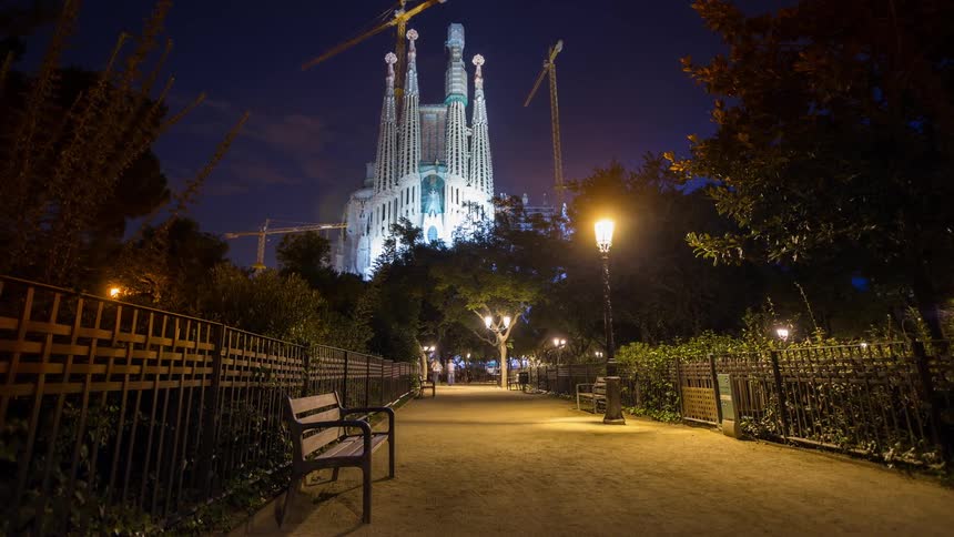 People walk in a city park at night