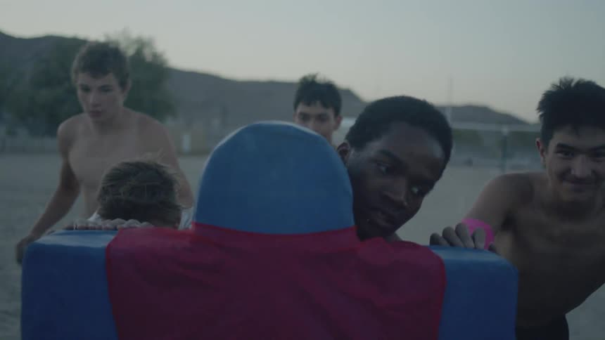 People pushing a football sled