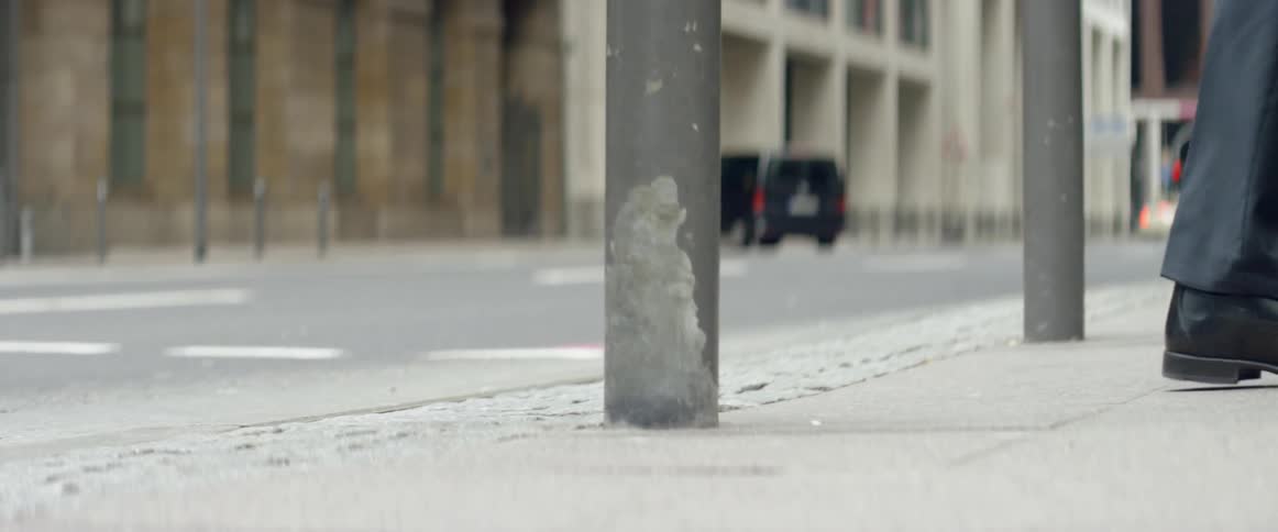 Peoples legs and shoes as they cross a city street
