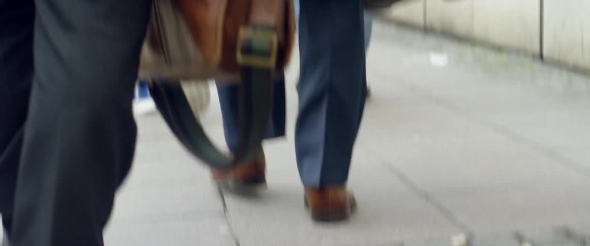 People walk on a city sidewalk