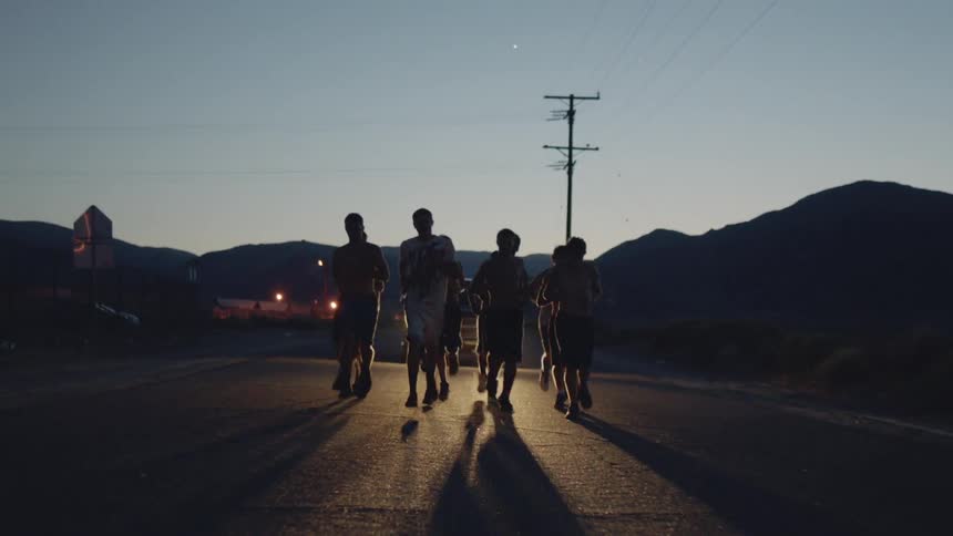 Men jogging down a street in the early morning