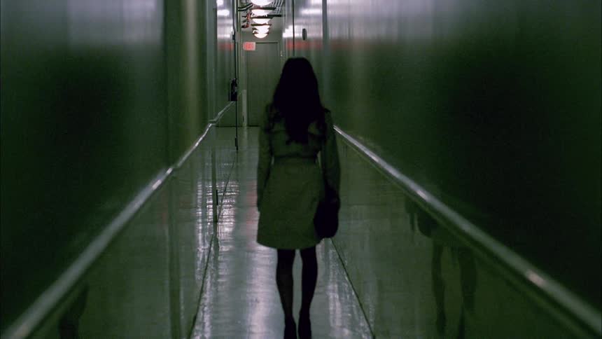 A woman walks in a hallway