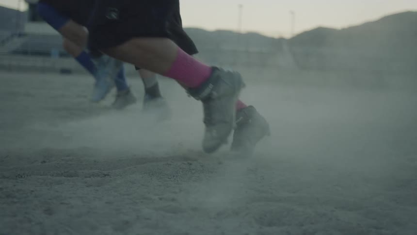 People charge at dummies on a field