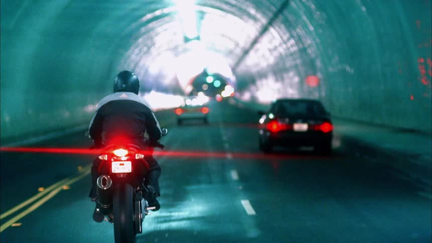 Someone is riding a motorcycle through a tunnel