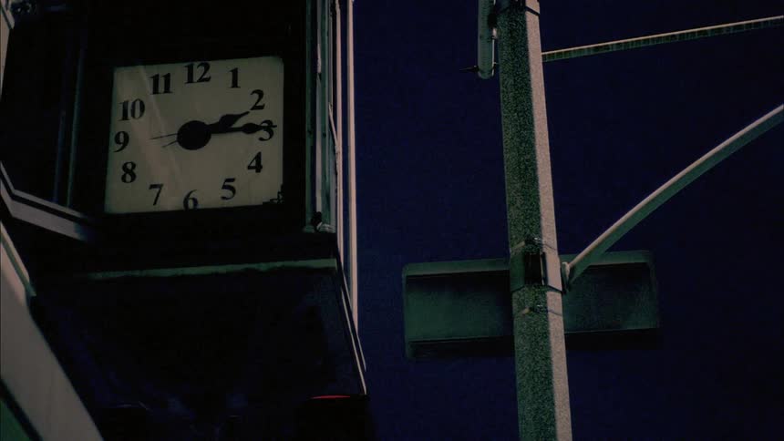 A clock hangs on a building