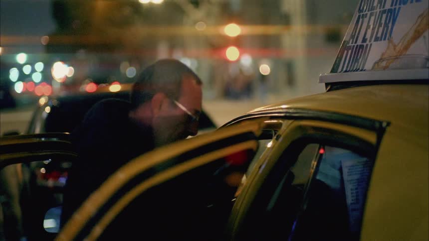 A woman climbs into a taxi