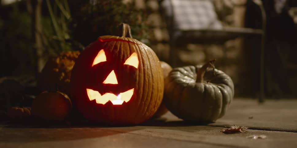 Carved pumpkin with a candle burning inside