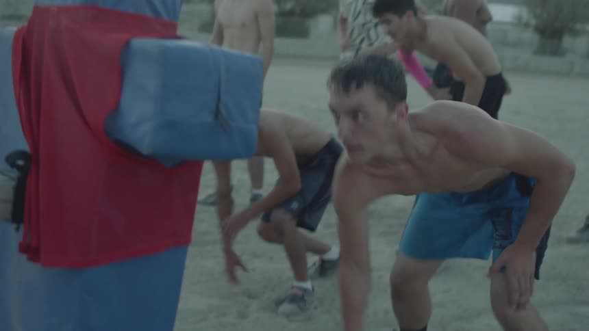People pushing a football sled