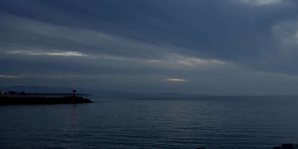 The light at the end of a jetty flashes
