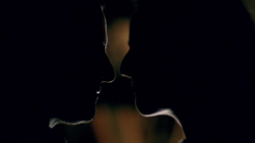 Two people kissing in the dark