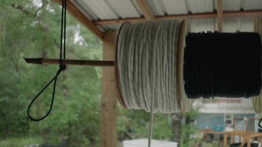 Rope is unwound from a hanging spool