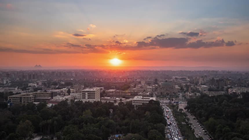 The sun sets over a city