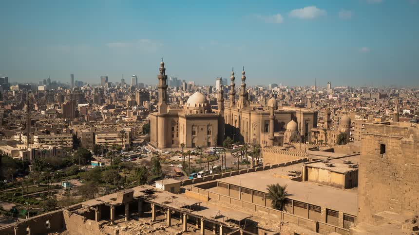 A large middle eastern city with many buildings and vehicles driving on roads