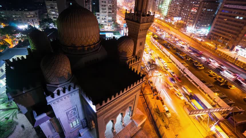 Traffic moves through a city at night