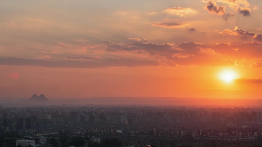 Time lapse of the sun shining over a large city