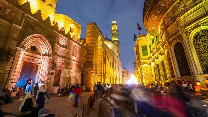 People walking on a sidewalk in a middle eastern city