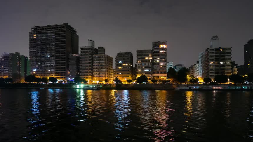 City lights reflect on a rippling river