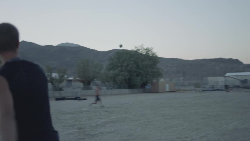 People playing football on a cloudy day