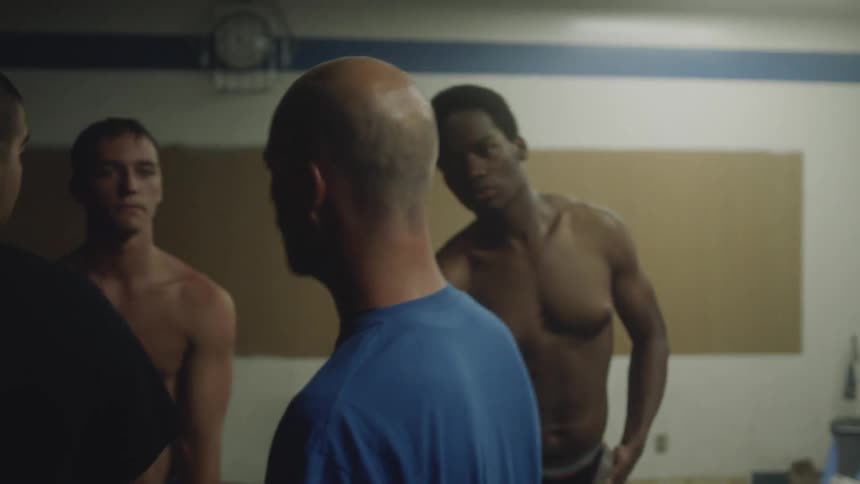Man talking to a group of people standing around him