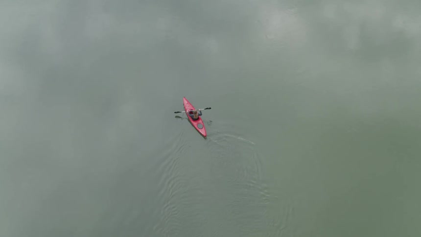 A person kayaks on a river