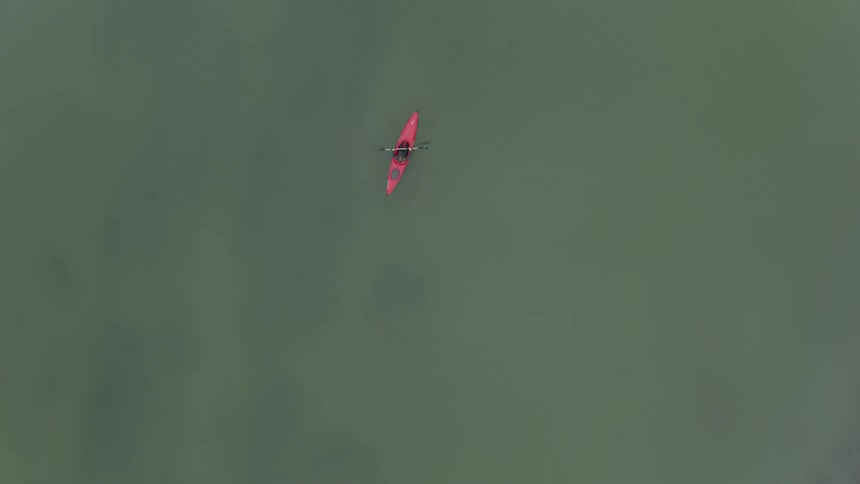 A person is kayaking in a river during the day