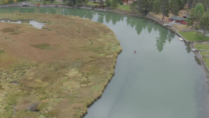 A person kayaks in a lake