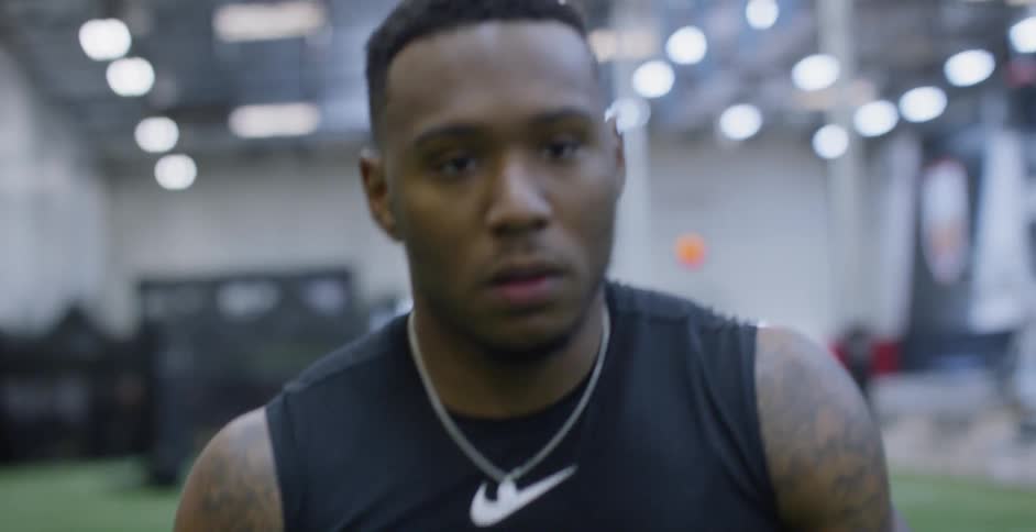 An athlete walks on an indoor field