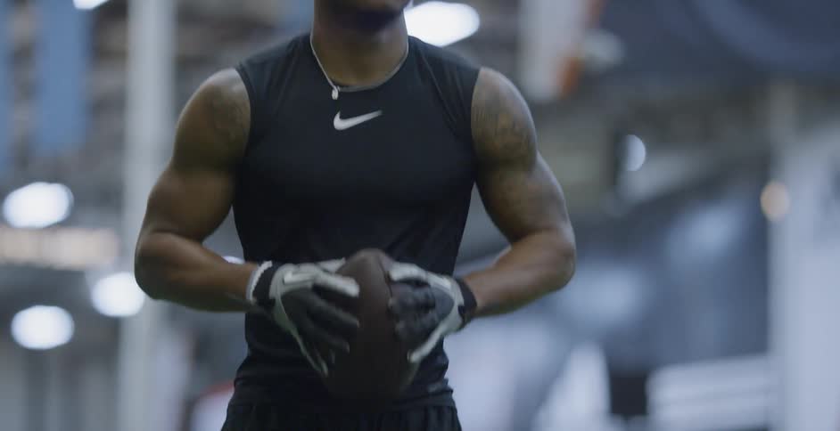 A football player jogs indoors
