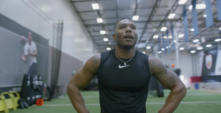 Man catches his breath as he walks in the gym