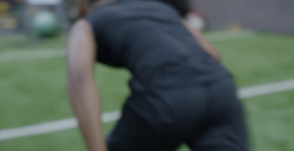 An athlete runs on an indoor field