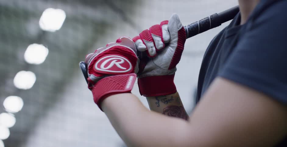 A female athlete is preparing to swing a baseball bat