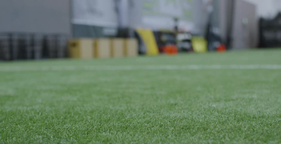 An athlete runs on an indoor field