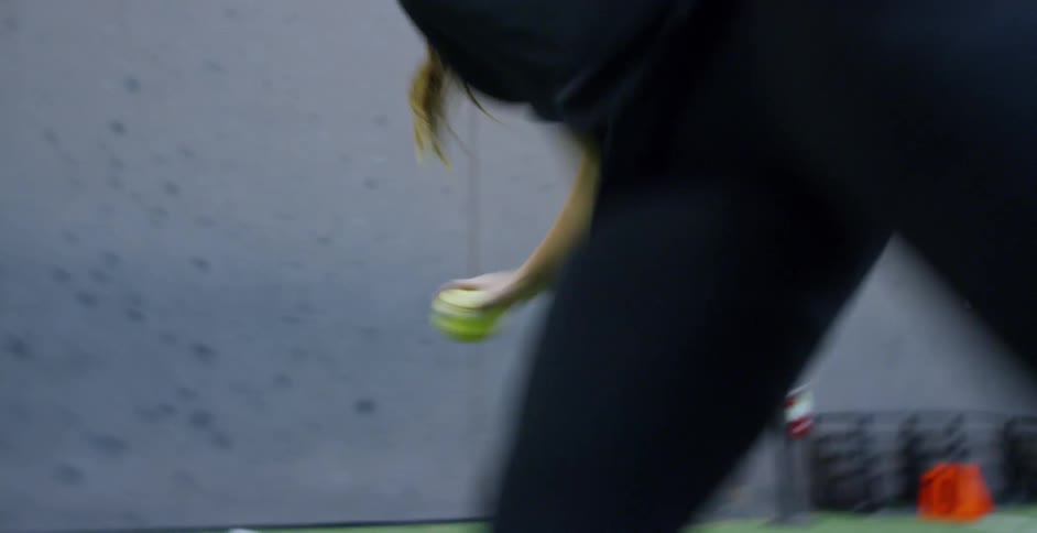 A woman trains for softball indoors