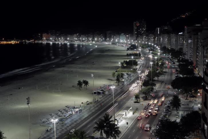 Vehicles and pedestrians commute in the city at night