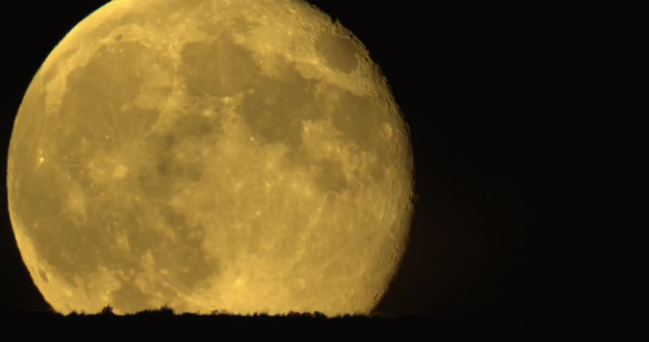 A person standing in front of the moon
