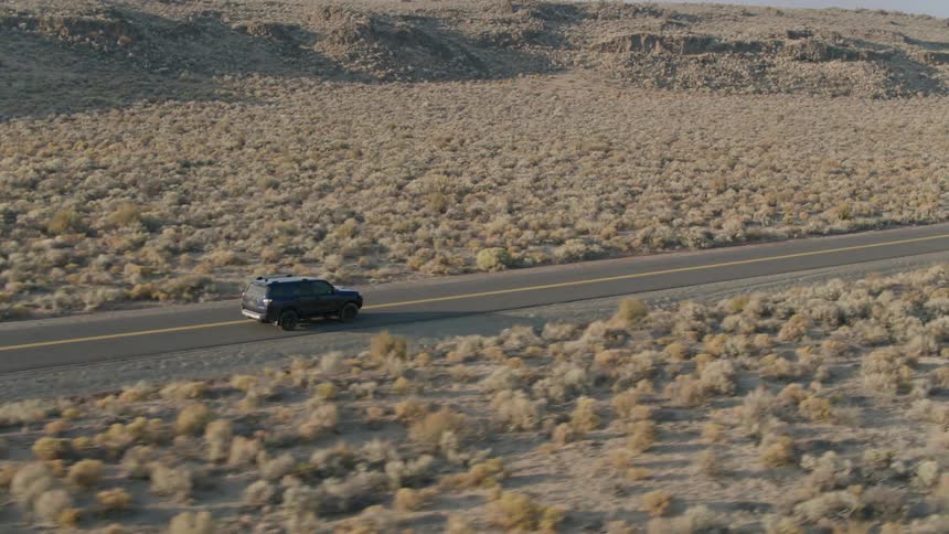 A truck drives down a rural road