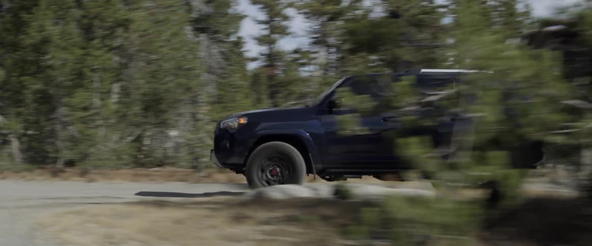 A truck drives up a mountain road
