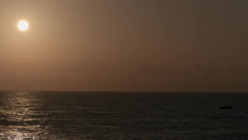 The sun shines brightly on the ocean water
